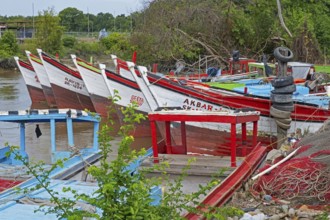 Colourful traditional wooden fishing boats moored along the coast of Guyana, South America