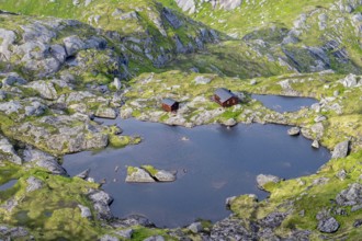 Mountain landscape with Munkebu mountain hut and small lakes, view from the ascent to Munken,