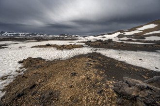 Snow-covered volcanic landscape with tuff and petrified lava, crater of Askja volcano, Icelandic