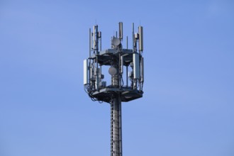 Mobile phone mast, transmission mast in front of sky, Hesse, Germany, Europe