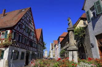 Typical Franconian village centre and the four-tube fountain in the village centre, Mainbernheim,