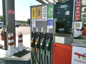 Petrol pump with nozzles for petrol and diesel at a motorway filling station in France, Automatic