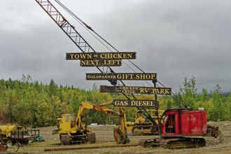 At the Top of the World Highway with signs to the wasteland settlement of Chicken, Interior Alaska,