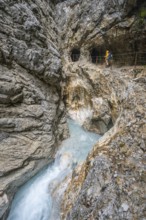 Hiker in a gorge, Hammersbach flows through Höllentalklamm, near Garmisch-Partenkirchen,