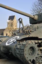 M4 Sherman tank in the Airborne Museum and parachute memorial in honour of paratrooper John Steele,