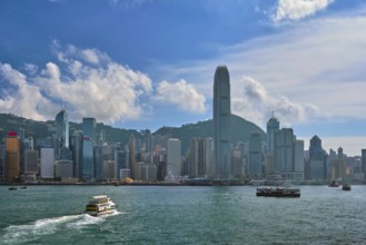 HONG KONG, CHINA, MAY 1, 2018: Boat in Victoria Harbour and Hong Kong skyline cityscape downtown