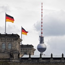 Reichstag, detail with German flags and Berlin television tower, German Bundestag, government