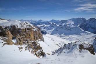 View of a ski resort piste and Dolomites mountains in Italy from Passo Pordoi pass. Arabba, Italy,