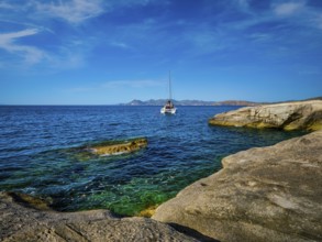 Yacht boat in Aegean sea at white rocks of Sarakiniko Beach, Milos island, Greece, Europe