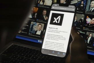 In this photo illustration, A person browses website of xAI, displayed on a mobile phone, Elon Musk