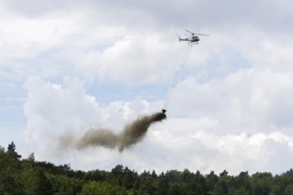 Symbolic image, climate change, helicopter, helicopter spreading finely painted limestone and wood