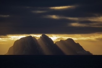 Island Værøy at the southern end of Lofoten under clouds with sunrays