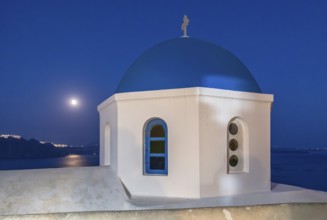 Full moon over blue-domed Church of Agios Nikolaos, Ia, Oia, Santorini, Greece, Europe