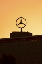 Mercedes star on Mercedes Benz branch in Stuttgart, after sunset, Baden-Württemberg, Germany,