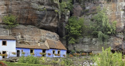 The blue troglodyte houses in rock face at Graufthal, Vosges, Alsace, France, Europe