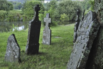 Headstones on 17th and 18th century graves of the old graveyard along the Semois river at Mortehan,