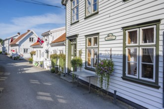 Alley with traditional wooden houses in Sogndalstrand, Sokndal, Rogaland, Norway, Europe