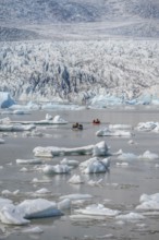 Boats with tourists in the glacier lagoon, ice lagoon Fjallsárlón, ice floes in front of glacier