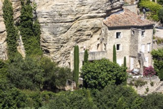 House on a rock face in the old town of Gordes, Vaucluse, Provence-Alpes-Cote dAzur, Provence,