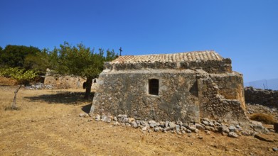 Agios Georgios, chapel, ruins of buildings, stone houses, dry meadow, cloudless blue sky, northeast