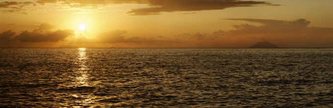 Sunset panorama on the beach of Tropea with the Aeolian (Liparic) Islands and the volcanic island