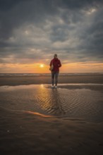 Tourist on the beach at sunset, Zandvoort, Netherlands