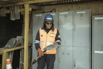 Adán Arenas Rodriguez, miner, handing out tools in the warehouse of the mining company Ecosem,