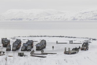 Military vehicles stand in a car park as part of the NATO exercise Nordic Response near