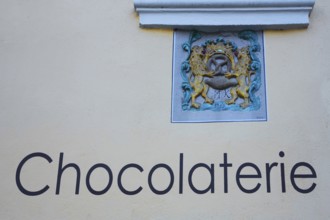 Coat of arms with pretzel, lion figures at the chocolaterie, chocolate house, confectionery,