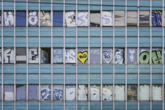 The logo of Berlin's public transport company BVG appears as graffiti on an empty office building