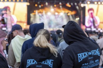 Adenau, Germany, 8 June 2024: Two people with Rock am Ring jumpers at the Rock am Ring Festival.