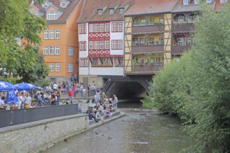 Famous Krämerbrücke and with river Gera and people sitting on the bank, idyll, half-timbered