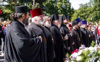 Russian Orthodox priests stand at the Soviet memorial on Straße des 17. Juni to commemorate the