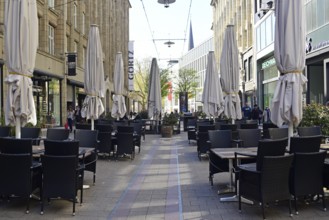 Europe, Germany, Hamburg, Closed outdoor restaurant in Spitaler Straße empty restaurant tables