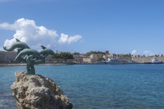 Dolphin statue in Kolona harbour, Rhodes, Dodecanese archipelago, Greek islands, Greece, Europe