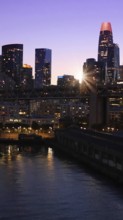 San Francisco Business Center panoramic city skyline view near Oakland Bay Bridge at sunset