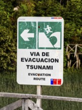 Signpost showing evacuation route in case of a tsunami, Caleta Tortel, Aysen region, Patagonia,