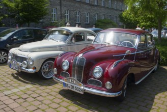 Two vintage cars in red and white parked next to each other in the shade, vintage car, Volvo PV