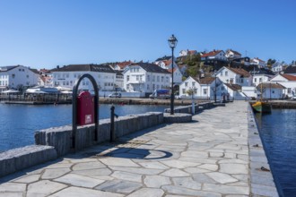 At the seaside in Risor, a traditional village with wooden white houses at the southern norwegian