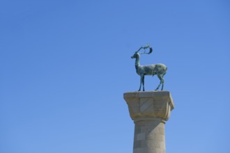 Stag Elafos, sculpture on a column, at the harbour entrance of Rhodes, Mandraki harbour, Rhodes,