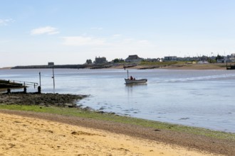 Ferry boat arriving at Bawdsey Quay, River Deben, Suffolk, England, UK