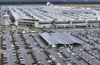 Tesla Giga Factory on the A10 motorway, on the right of the picture is a photovoltaic system above