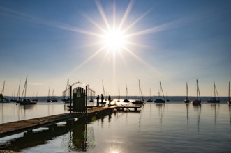 Jetty on the Lake Ammer backlit, Bavaria, Germany, Europe