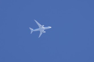 Boeing 787-8 Dreamliner jet aircraft of TUI airlines flying in a blue sky, England, United Kingdom,