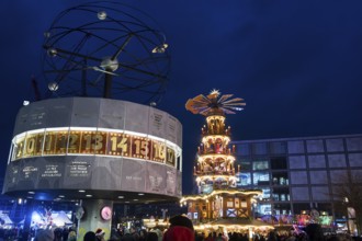 A Christmas pyramid behind the World Time Clock at the Christmas market on Alexanderplatz, Berlin,