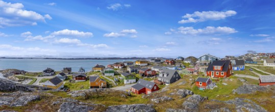 Typical architecture of Greenland capital Nuuk with colored houses located near fjords and icebergs