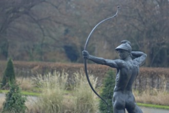 Sculpture Archer by Ernst Moritz Geyger 1895, athletic male figure with bow, bronze sculpture,