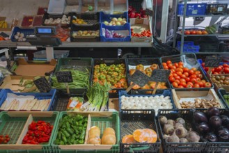 Market stall with a wide selection of fresh vegetables such as tomatoes and aubergines, San