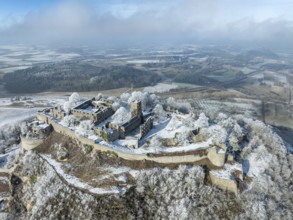 Aerial view of the snow-covered Hegau volcano Hohentwiel with Germany's largest castle ruins,