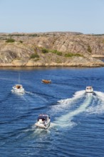 Boats at sea by a rocky archipelago on the Swedish west coast on a beautiful summer day,